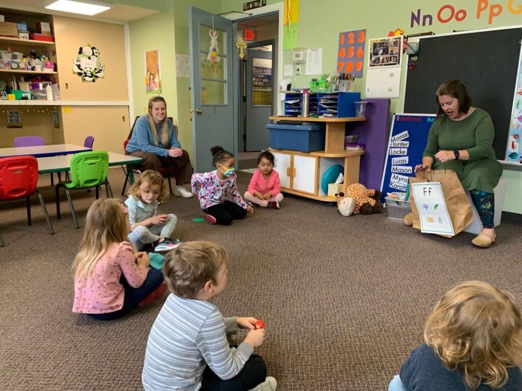 Children at circle time listening to teacher