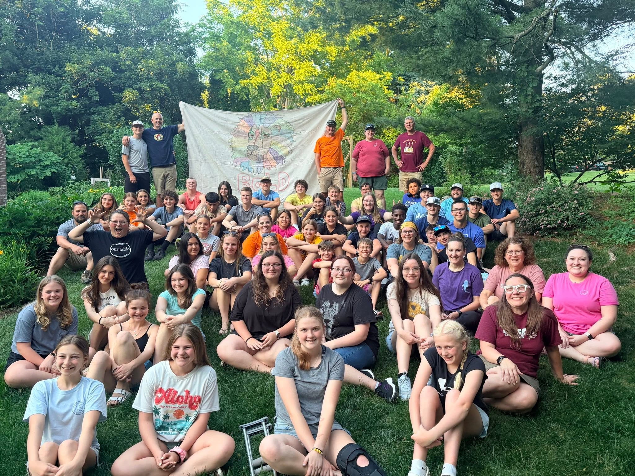 Students gathering on the lawn of a home
